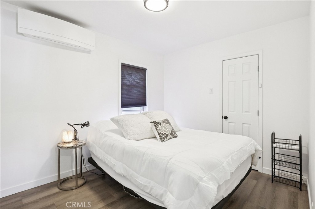 1448 Lemon Avenue Long Beach, CA 90813 - Photo 10 of 16 a bedroom with a bed and wooden floor