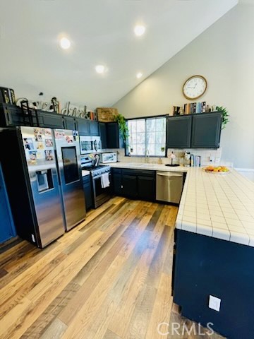 26620 Modoc Lane Lake Arrowhead, CA 92352 - Photo 11 of 14 a large kitchen with a table chairs and a wooden floor
