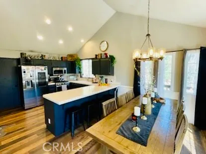 a large kitchen with a table chairs and a wooden floor