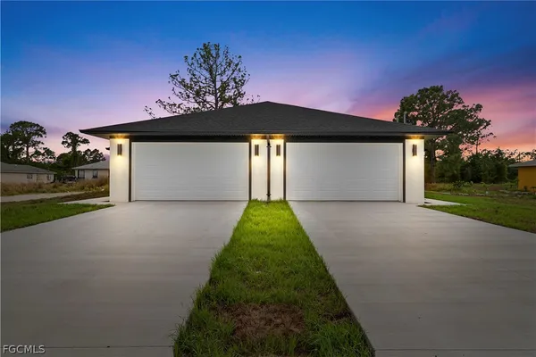 a front view of a house with a yard and garage
