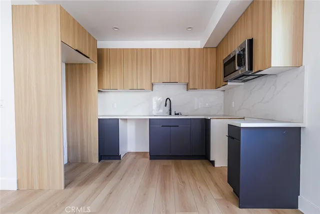 a kitchen with a sink cabinets and stainless steel appliances