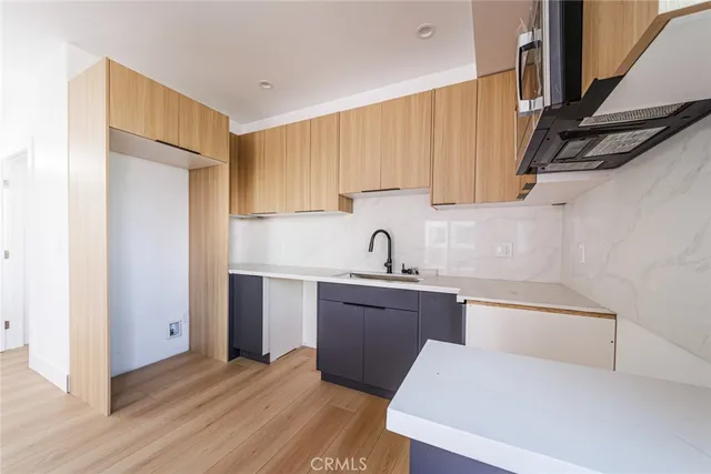 a kitchen with stainless steel appliances granite countertop a refrigerator sink and cabinets