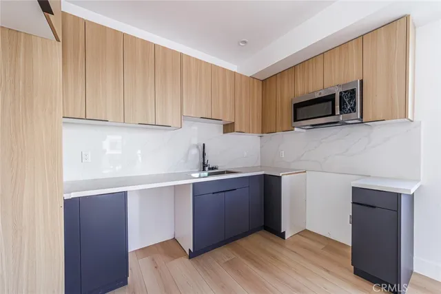 a kitchen with stainless steel appliances granite countertop a sink stove and microwave