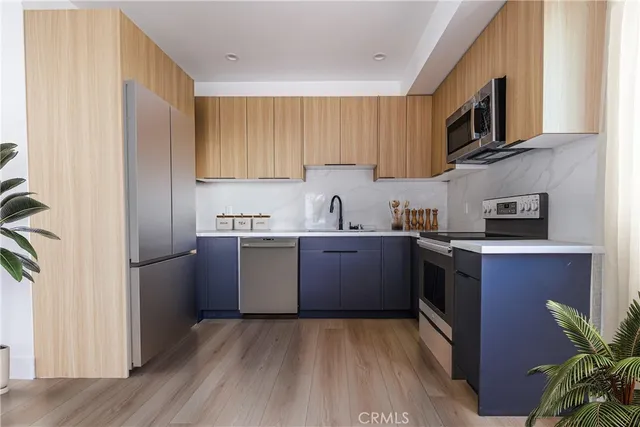 a kitchen with a refrigerator sink and microwave