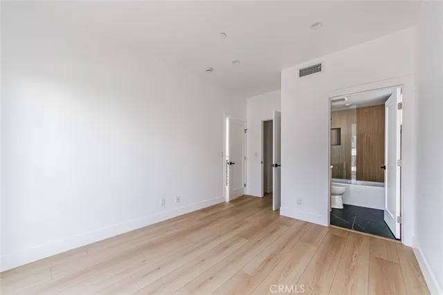 a view of a room with wooden floor and brick walls