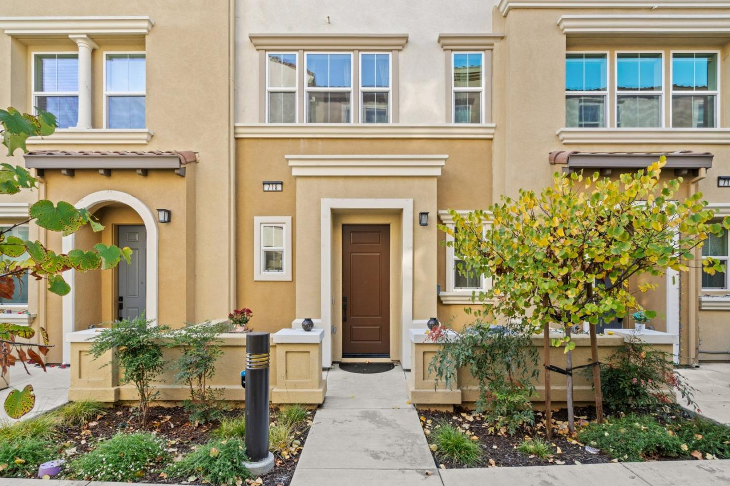 718 Amalfi Loop Milpitas, CA 95035 - Photo 1 of 37 a front view of a house with a garden