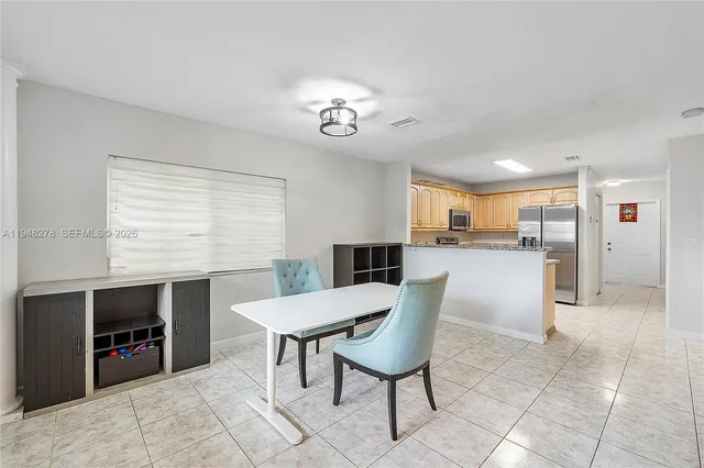a dining room with furniture and window