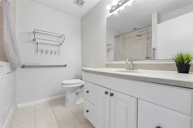 a bathroom with a sink a mirror and a shower