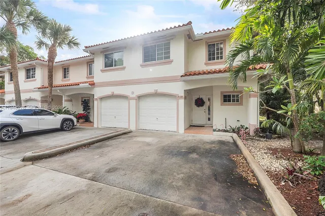 a view of a white apartments with large windows
