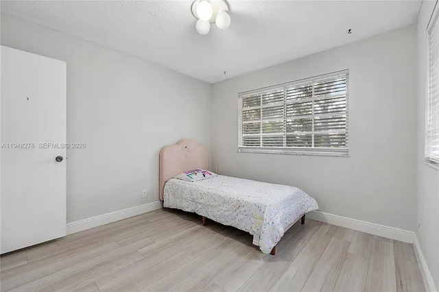 a view of a workspace with furniture and a flat screen tv