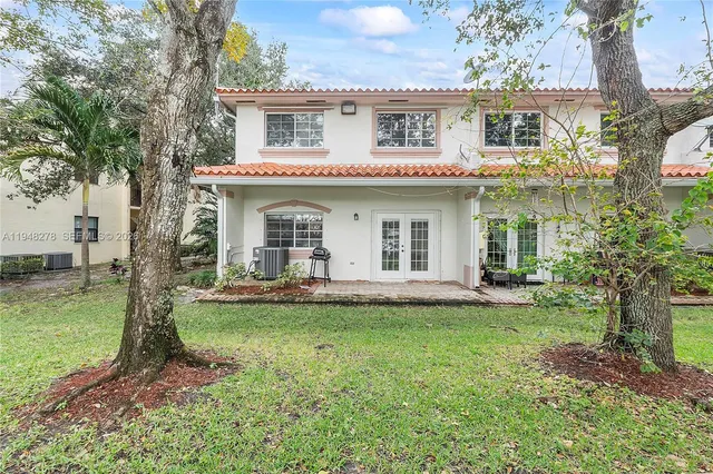 a view of a house with a yard and sitting area