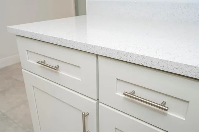 a large kitchen with cabinets and stainless steel appliances