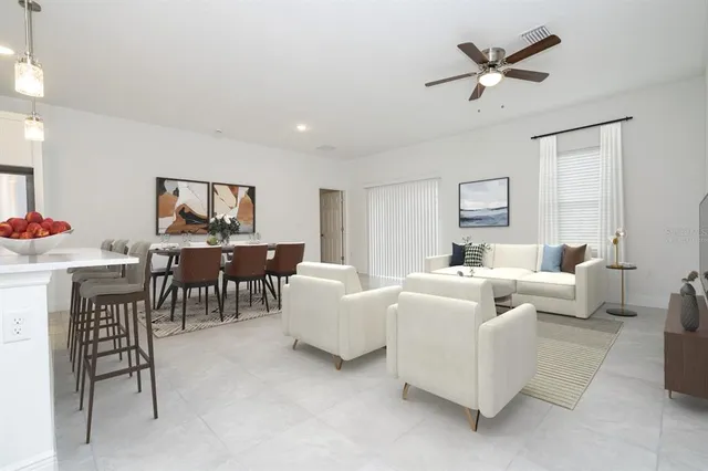 an empty room with a ceiling fan and a window