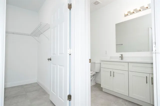 a bathroom with a shower sink and mirror