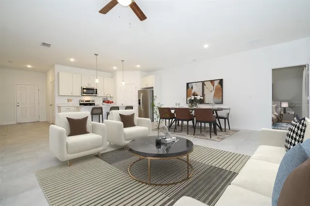 a living room with furniture and kitchen view