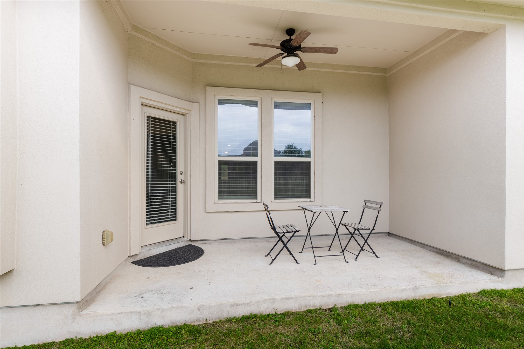 5012 Yucca Bloom Drive Georgetown, TX 78626 - Photo 25 of 35 Covered outdoor patio featuring a ceiling fan, concrete flooring, exterior door with integrated blinds, and an exterior window