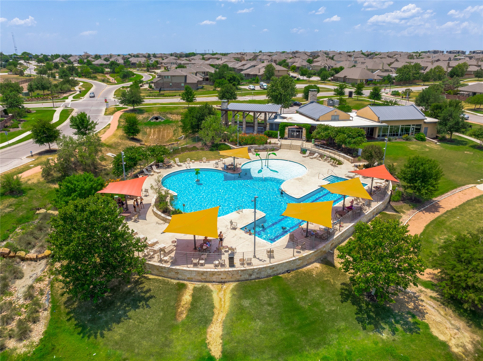 5012 Yucca Bloom Drive Georgetown, TX 78626 - Photo 32 of 35 Expansive community pool with multiple shaded seating areas and lounge chairs