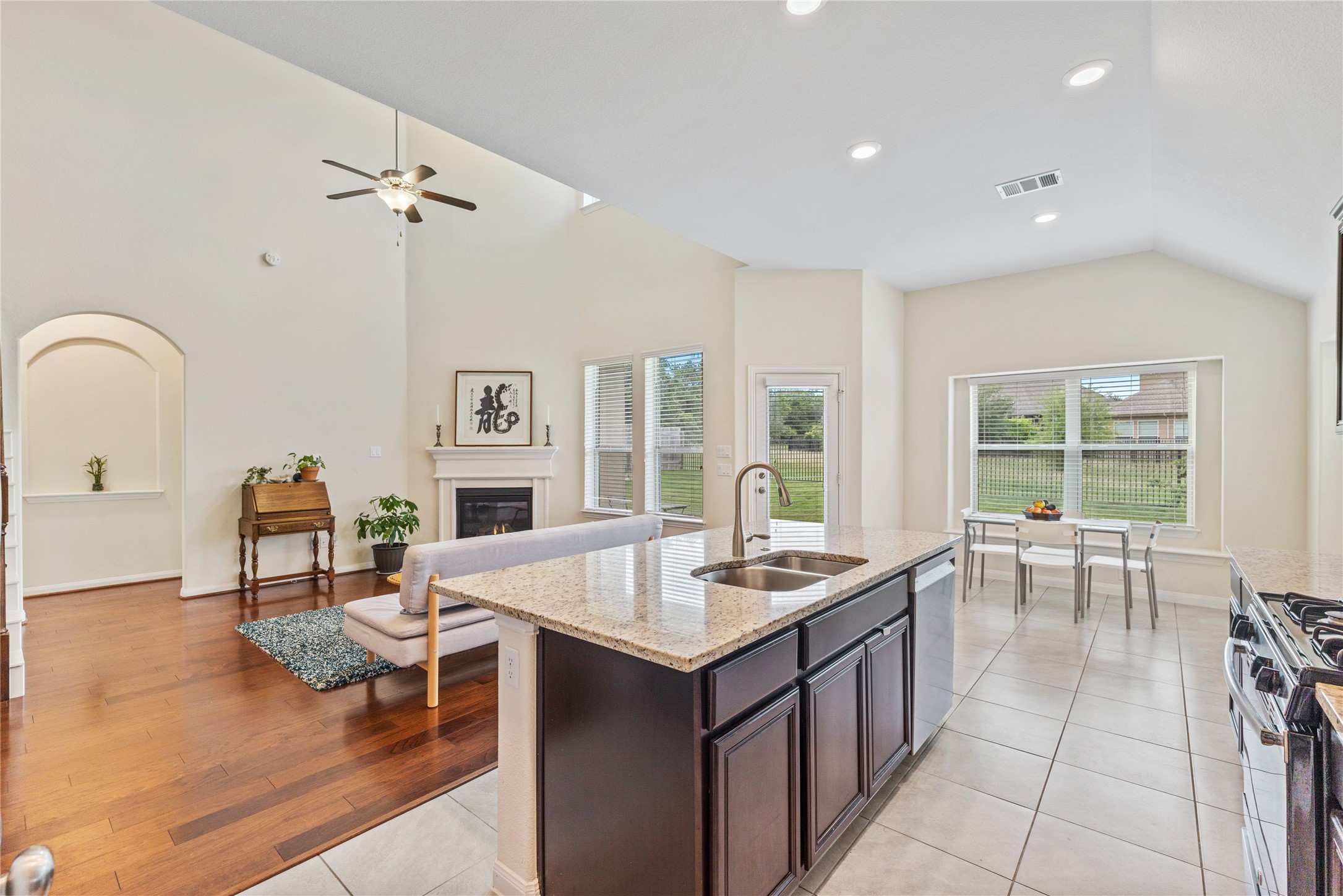 5012 Yucca Bloom Drive Georgetown, TX 78626 - Photo 8 of 35 Open-concept kitchen and living area featuring high vaulted ceilings, recessed lighting, and a prominent kitchen island with a double basin sink