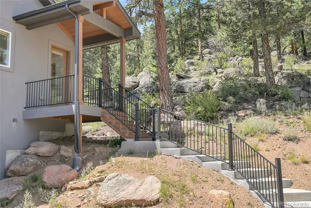 a view of a balcony with yard