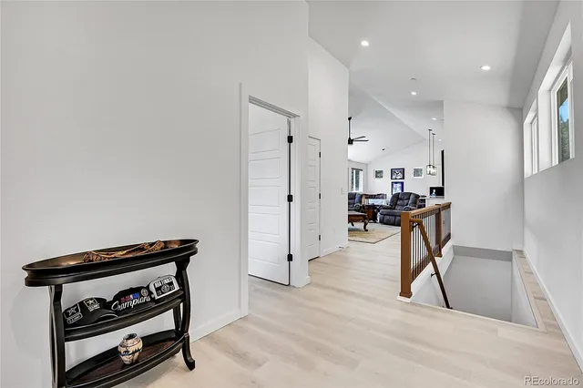 a view of entryway and hall with wooden floor