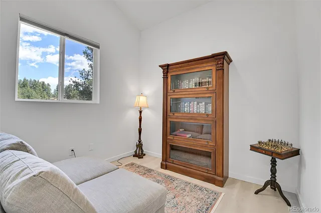 a living room with furniture a rug and a chandelier