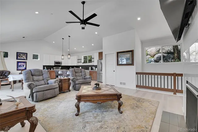 a living room with furniture kitchen and a table