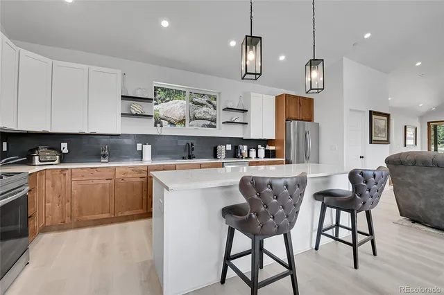 a large white kitchen with a large window