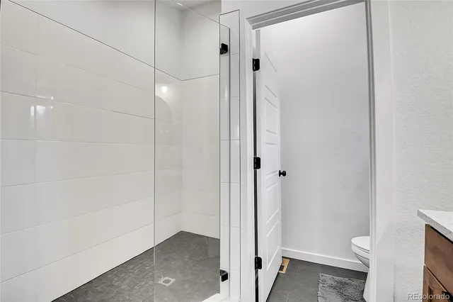 a bathroom with a toilet a sink and a shower