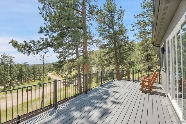 a view of balcony with wooden floor and fence