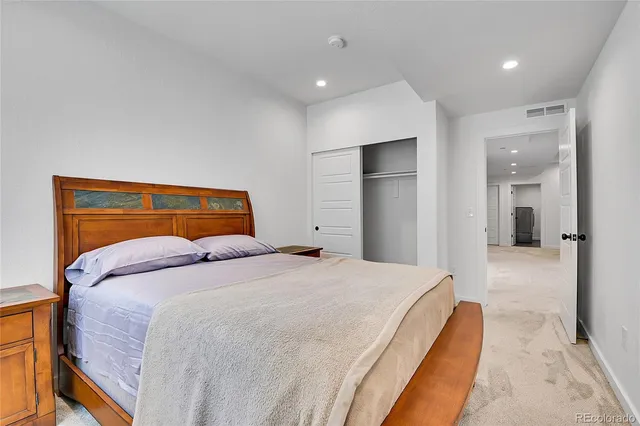 a large white kitchen with lots of counter space a sink appliances and a large window
