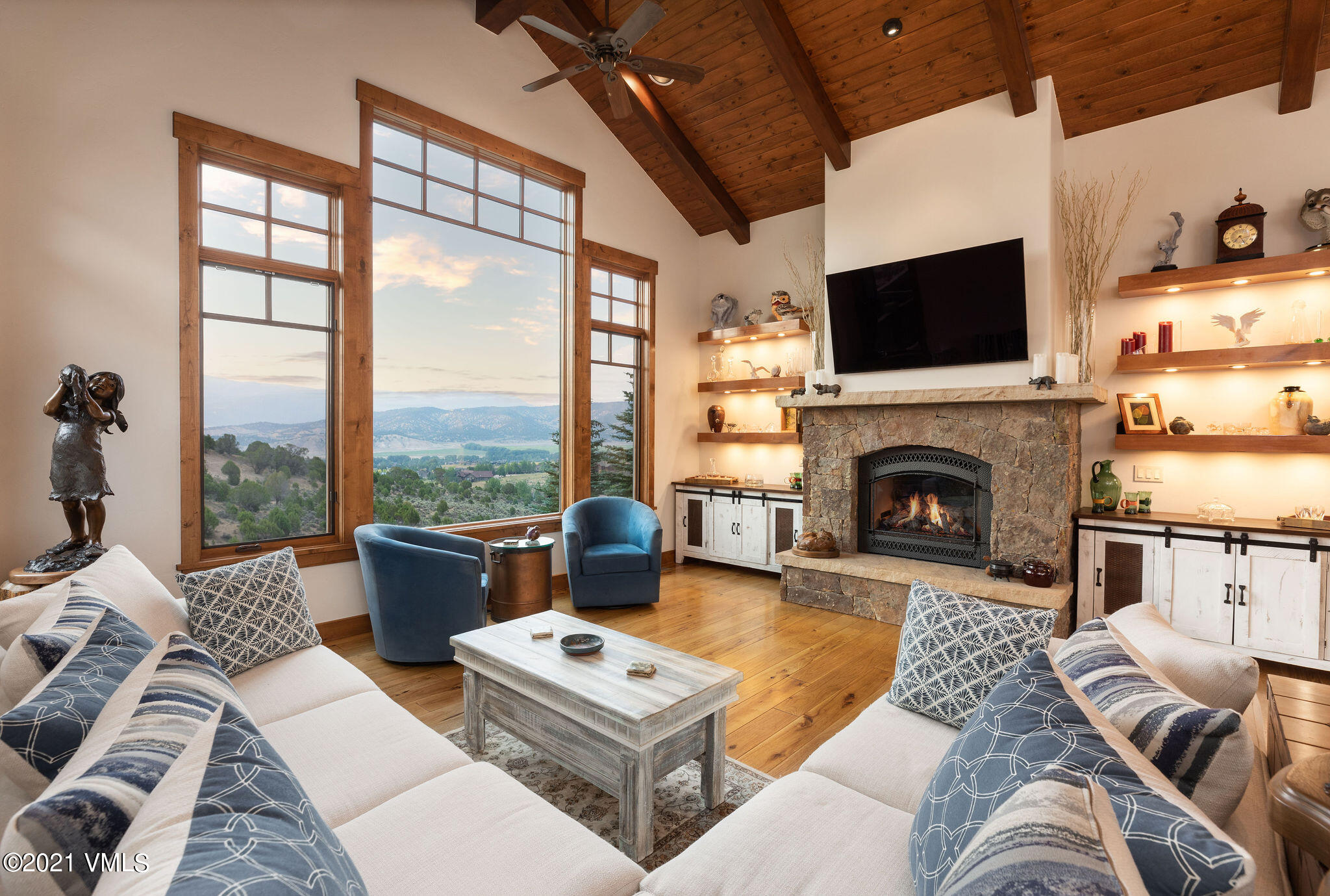 1168 Hernage Creek Road Eagle, CO 81631 - Photo 6 of 22 a living room with furniture a flat screen tv and a fireplace
