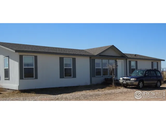 a bed sitting in a bedroom next to a window with tv