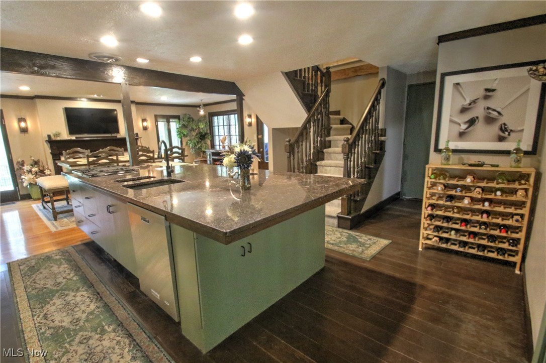 11375 Bean Road Chardon, OH 44024 - Photo 14 of 50 Kitchen with dark stone countertops, stainless steel dishwasher, dark wood finished floors, recessed lighting, and a center island with sink