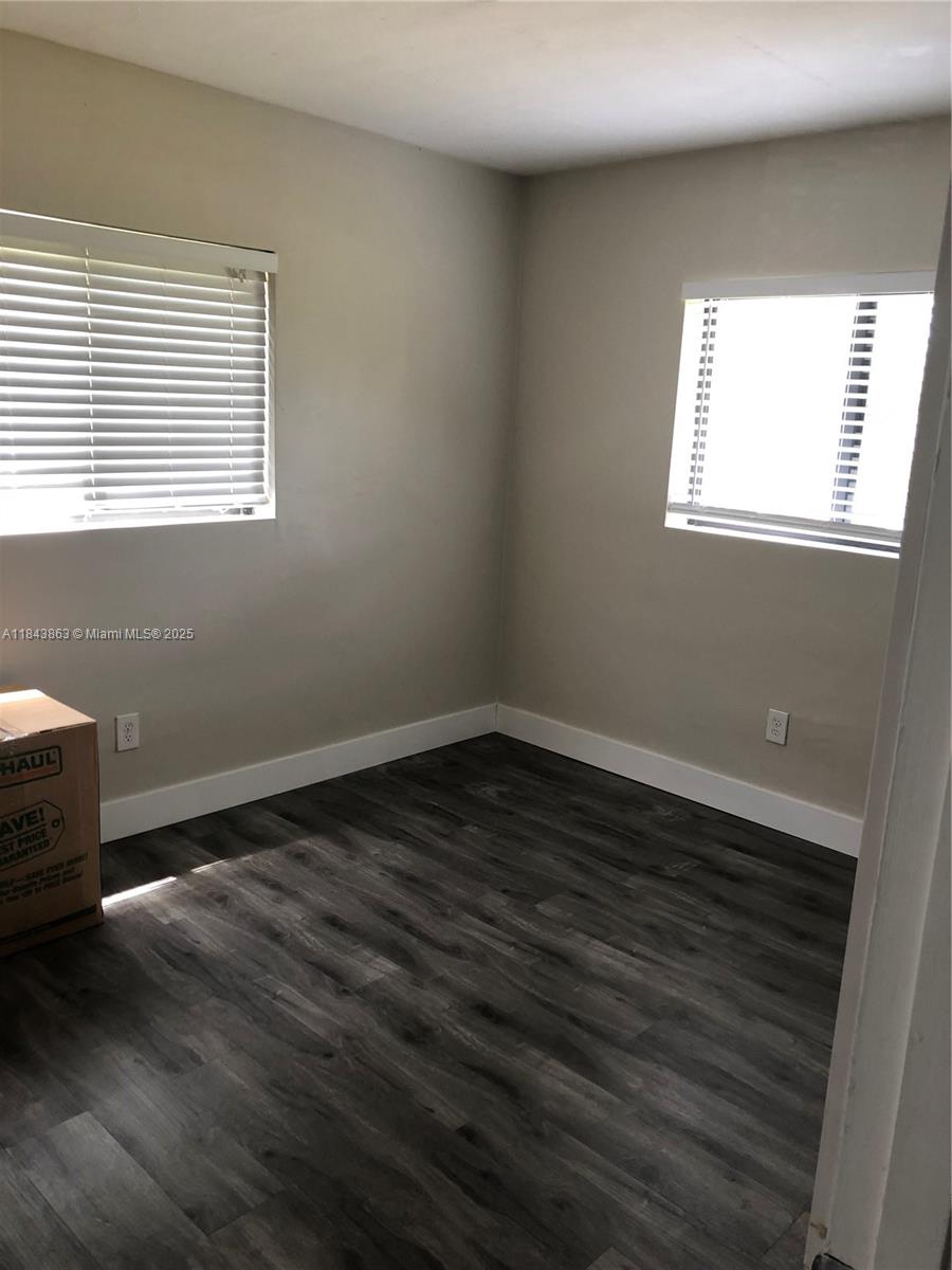 10801 Southwest 123rd Street Miami, FL 33176 - Photo 12 of 25 a view of an empty room with wooden floor and a window