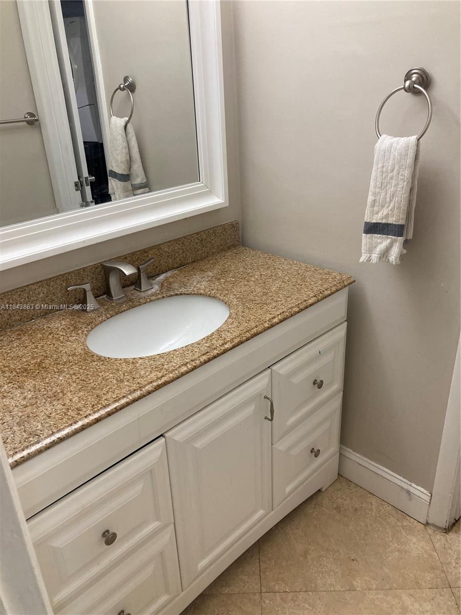10801 Southwest 123rd Street Miami, FL 33176 - Photo 13 of 25 a bathroom with a granite countertop sink and a mirror