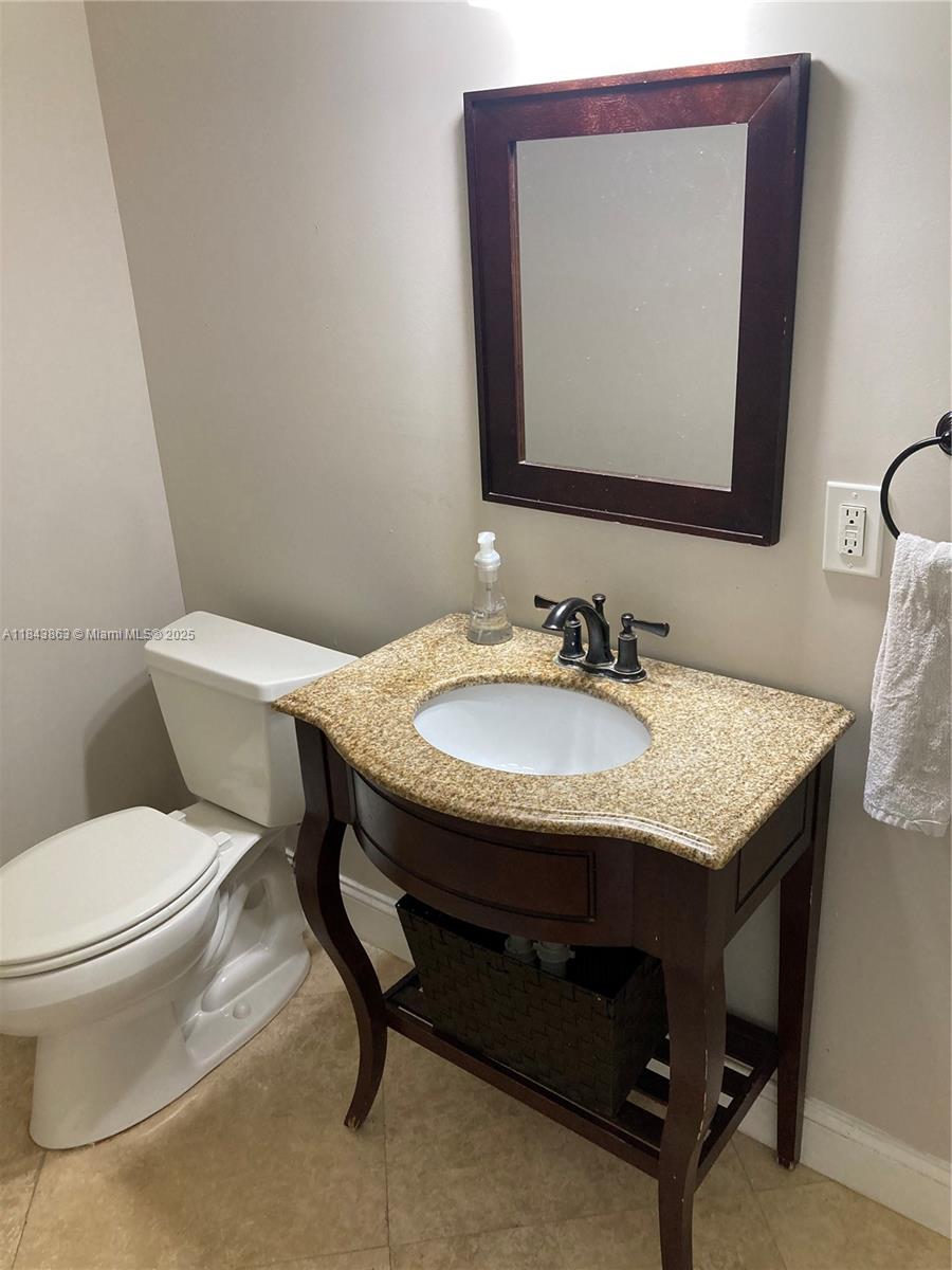 10801 Southwest 123rd Street Miami, FL 33176 - Photo 8 of 25 a bathroom with a toilet a sink and mirror