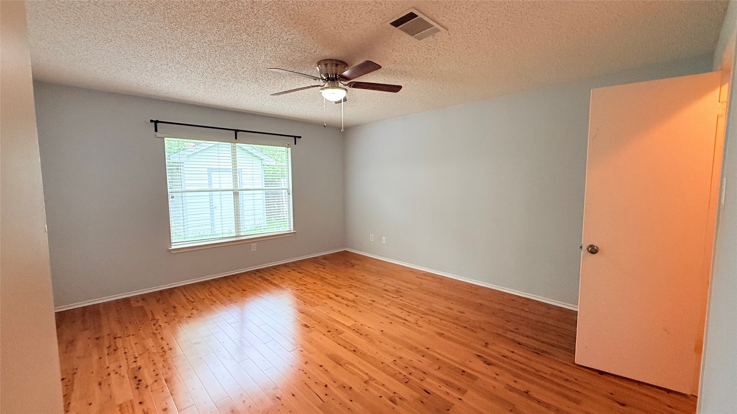 3324 Perch Trail Round Rock, TX 78665 - Photo 26 of 29 an empty room with wooden floor chandelier fan and windows