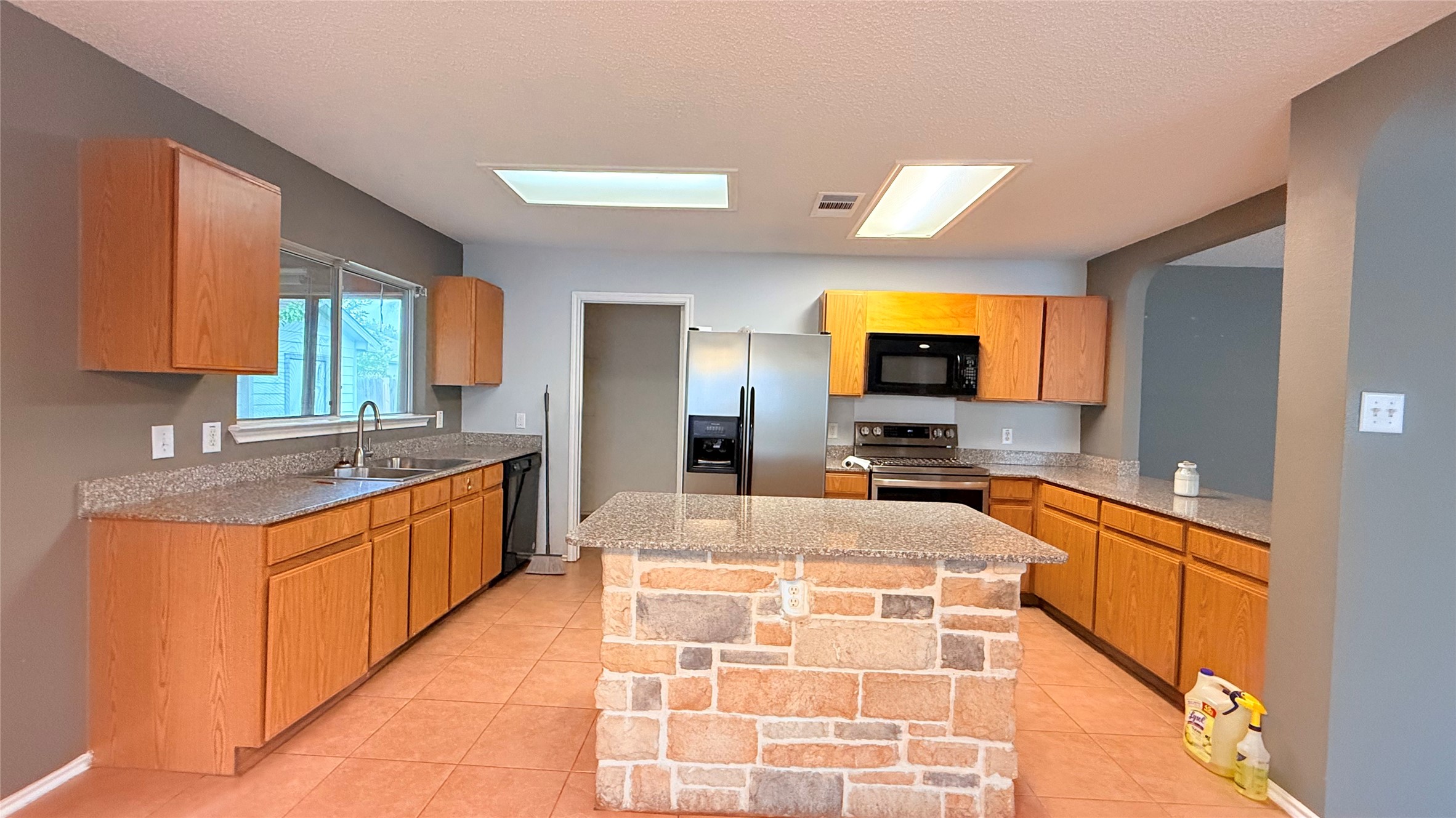 3324 Perch Trail Round Rock, TX 78665 - Photo 7 of 29 a large kitchen with kitchen island a sink stainless steel appliances and cabinets