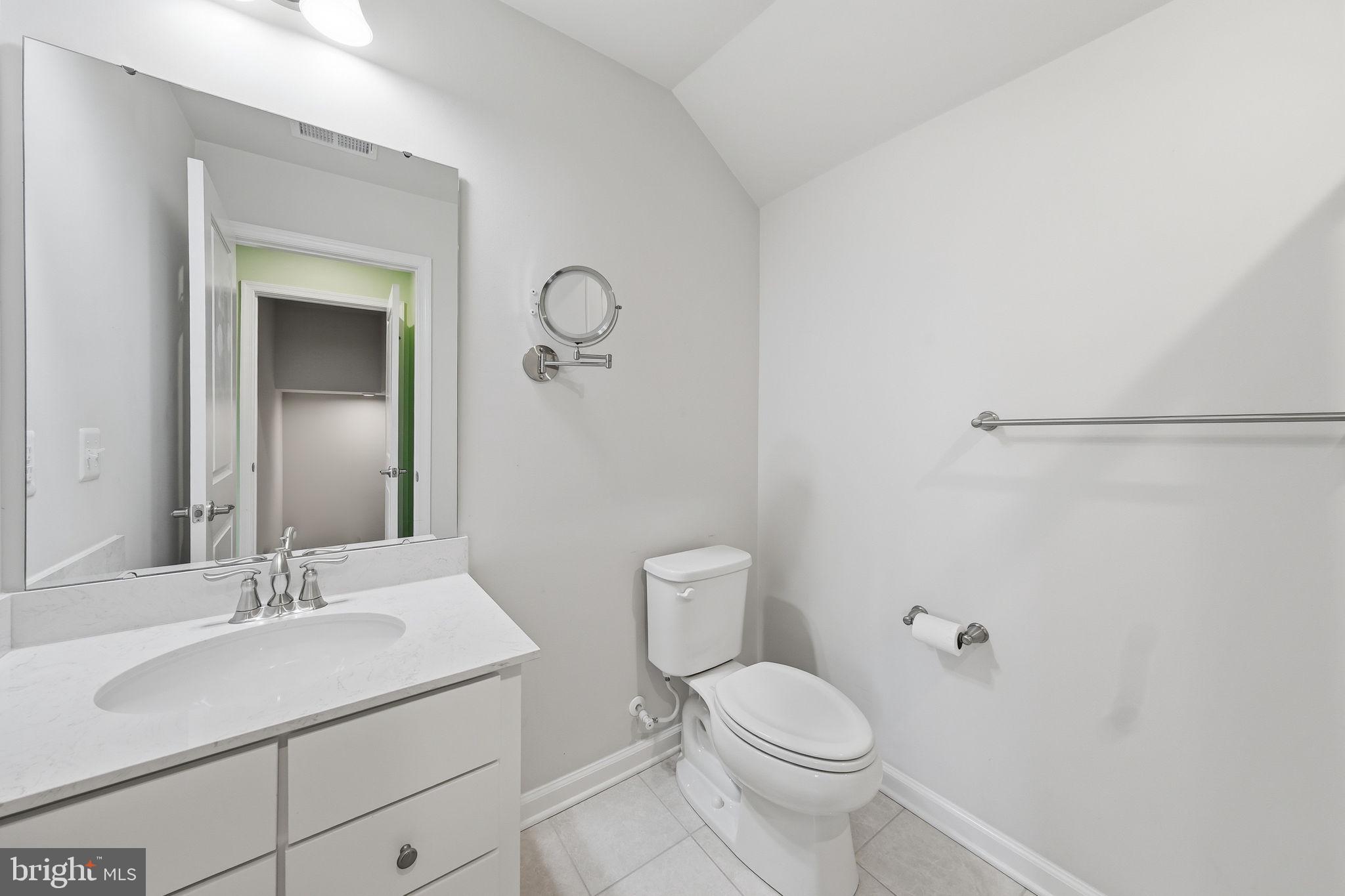 3012 Bretons Ridge Way Hanover, MD 21076 - Photo 33 of 37 a bathroom with a toilet sink vanity and mirror