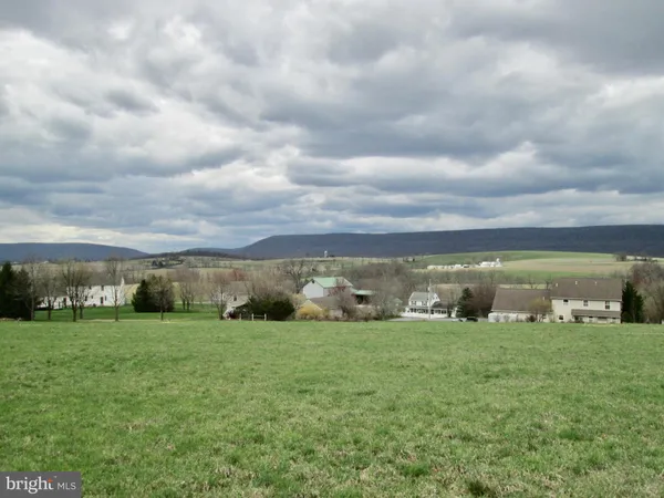 a view of a building with green field