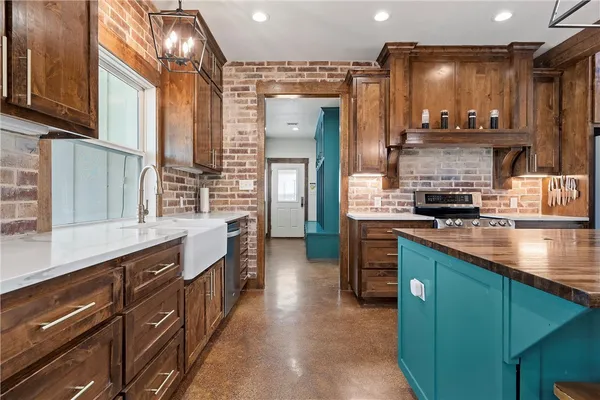 a kitchen with stainless steel appliances granite countertop a stove and cabinets