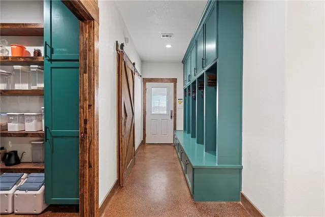a view of hallway with stairs and furniture