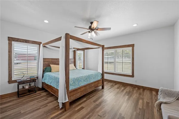 a bedroom with a bed and wooden floor