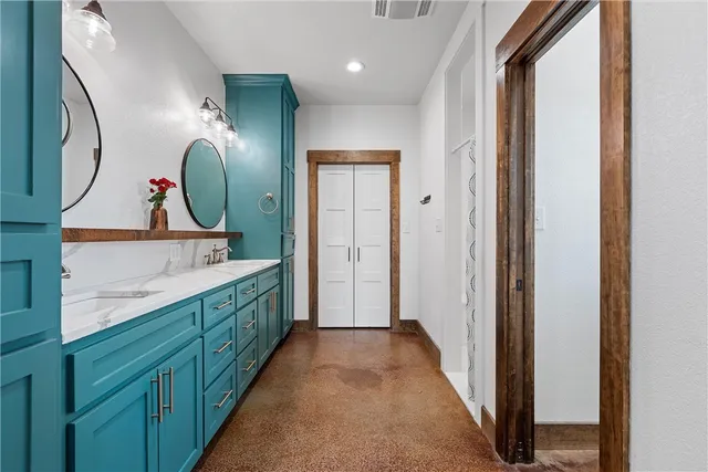 a bathroom with a sink a mirror a vanity and a shower