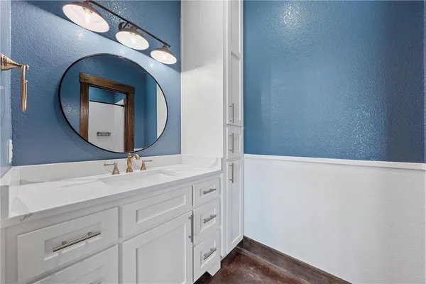 a bathroom with a sink and mirror