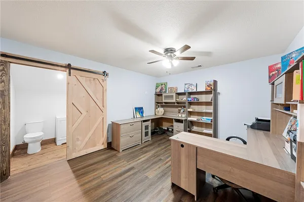 a view of a workspace with furniture and wooden floor