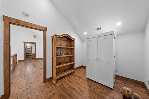 a view of room with wooden floor and closet