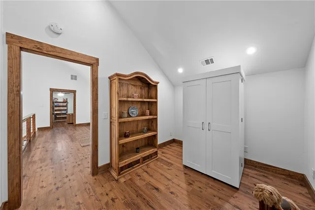 a view of room with wooden floor and closet
