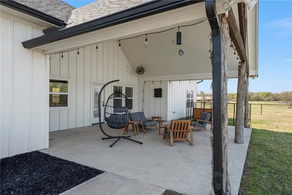 a view of a hallway with furniture and front door