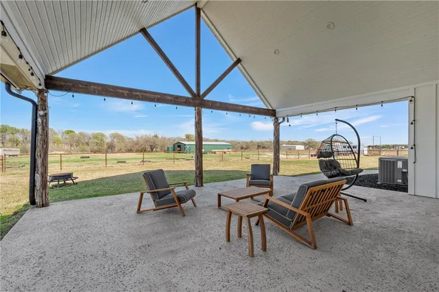 a living room with furniture and floor to ceiling windows
